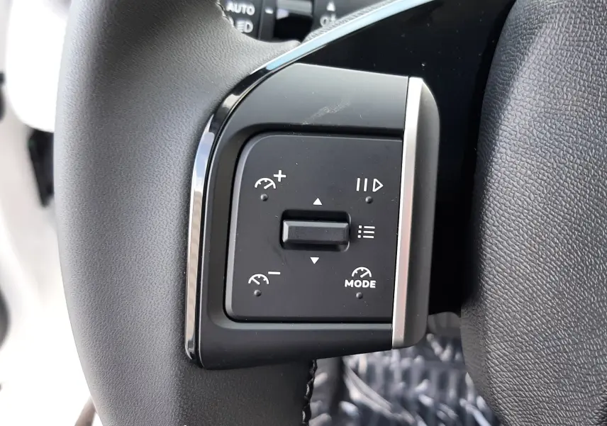 Gros plan sur les commandes de régulateur de vitesse au volant noir du Citroën C3 Aircross hybride 2026.
