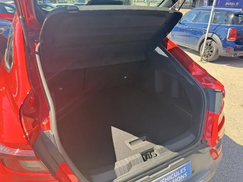 Coffre ouvert vu de l'arrière droit d'un Renault Arkana Rouge Flamme 2022, montrant l'espace de chargement vide.