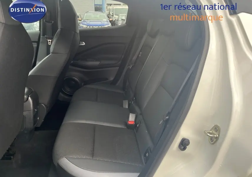 Vue intérieure côté droit montrant la banquette arrière en tissu noir du Nissan Juke blanc nacré 2024.