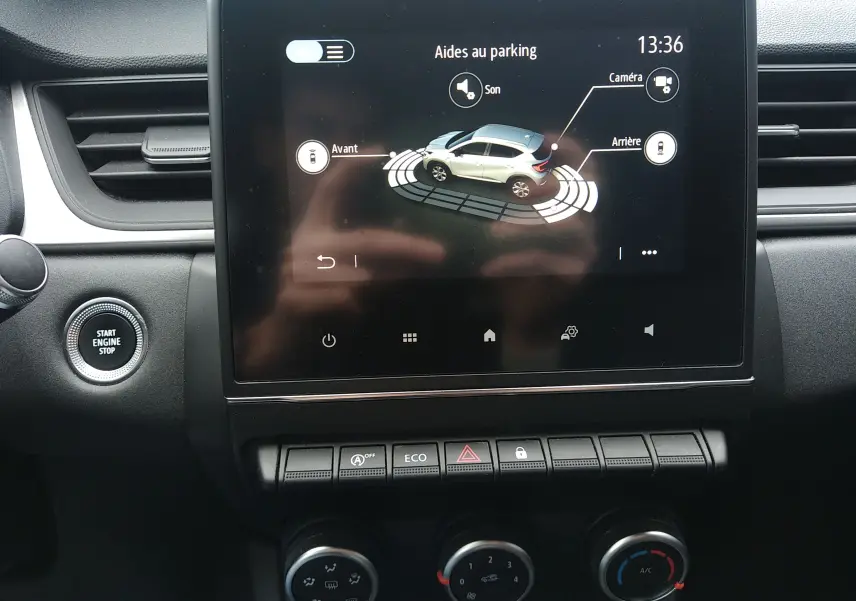 Écran tactile central du Renault Captur noir 2021 montrant l'aide au parking avec vue 3D du véhicule et commandes climatisation.