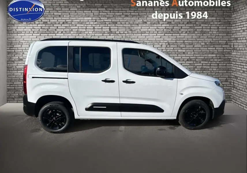 Vue de profil côté gauche d'un Citroën Berlingo blanc avec jantes noires et vitres arrière surteintées.