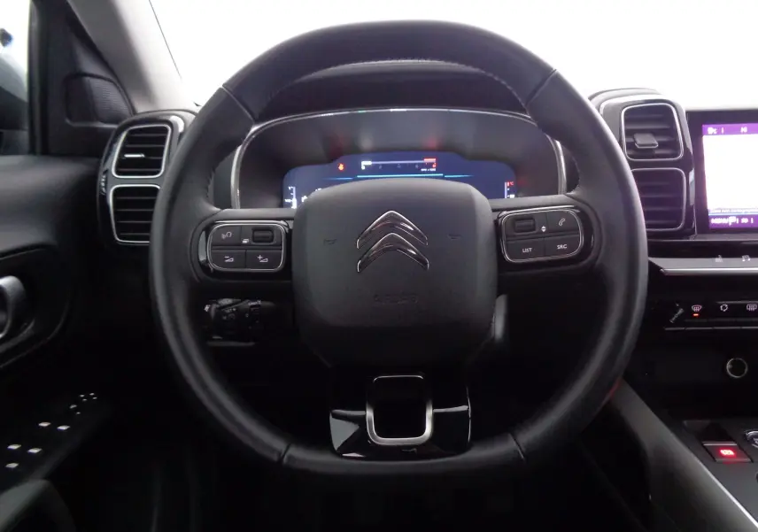 Vue centrée sur le volant noir du Citroën C5 Aircross 2021 avec commandes intégrées et tableau de bord numérique.