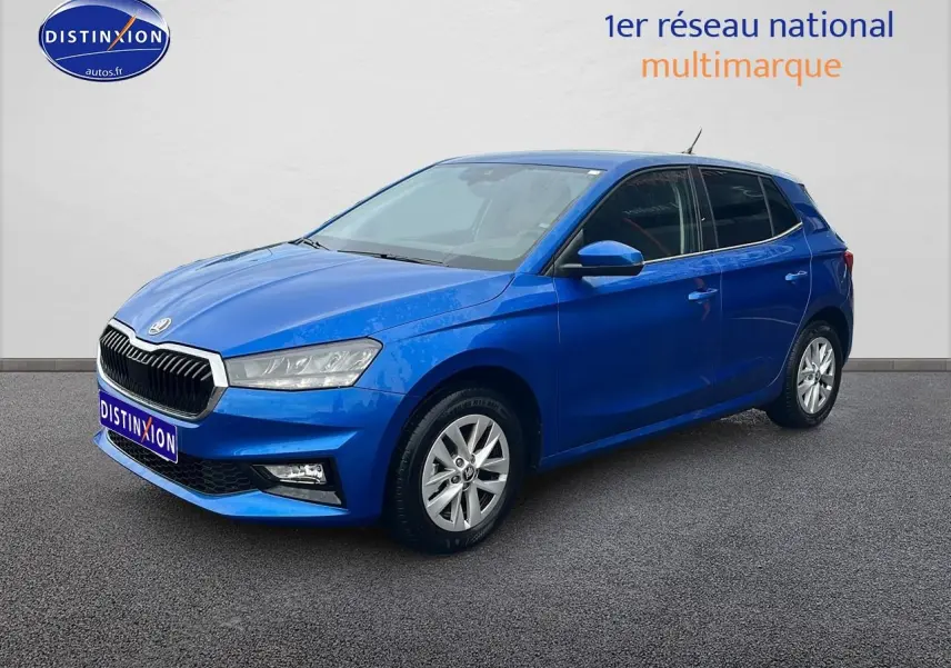 Vue 3/4 avant d'une Skoda Fabia bleu vif avec jantes alu et phares avant LED sur fond neutre.