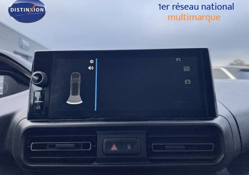 Écran tactile central du tableau de bord du Peugeot Partner 2025, affichant l'aide au stationnement.