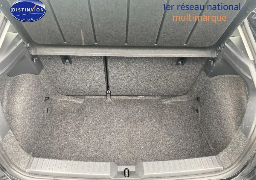 Coffre ouvert vu de l'arrière d'une SEAT Ibiza noir minuit, montrant l'espace de chargement et la moquette grise.