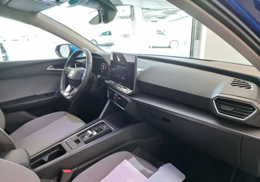 Vue intérieure côté conducteur du SEAT LEON 1.5 eTSI 115 DSG7 Copa 2025 avec écran central vertical et volant multifonction.