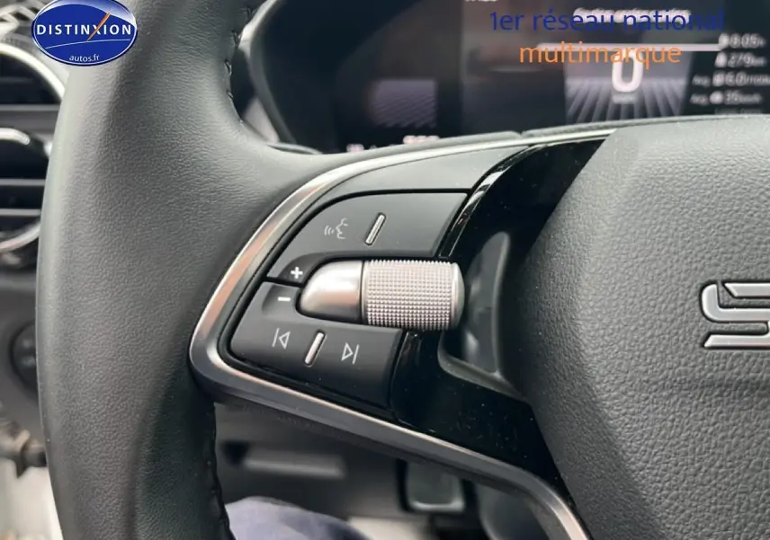Gros plan sur les commandes audio au volant cuir noir de la Skoda Fabia blanche 2025, version 1.0 TSI Evo2.
