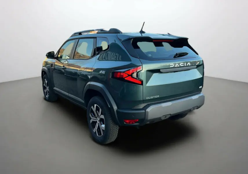 Vue 3/4 arrière droite d'un Dacia Duster 2025 vert cèdre avec logo et feux arrière en forme de flèche rouge.