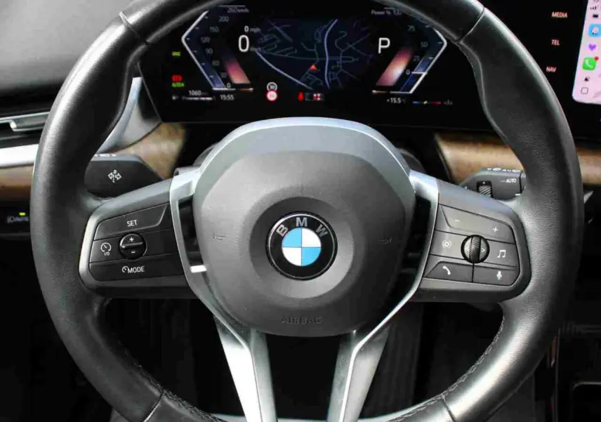 Volant sport cuir noir BMW Série 2 Active Tourer 2023 vu de face avec commandes multifonctions visibles.