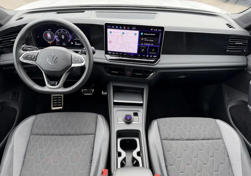 Vue intérieure frontale du Volkswagen Tiguan 2025, avec tableau de bord numérique et écran tactile central lumineux.
