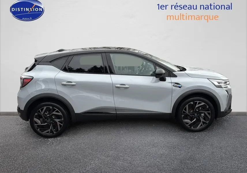 Profil droit du Renault Captur 2025 gris rafale avec toit noir et jantes alliage noires distinctives.
