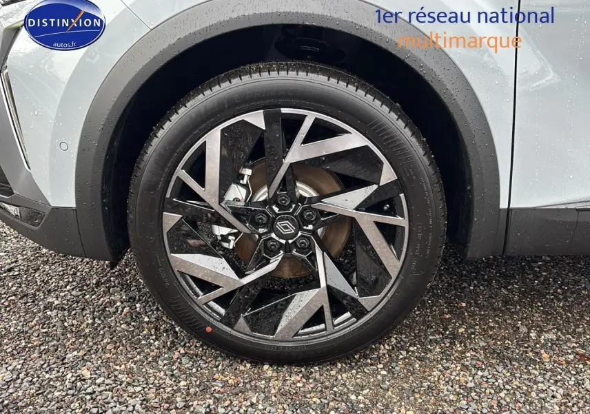 Gros plan sur la roue avant droite avec jante alu noire et argent du Renault Captur gris rafale.