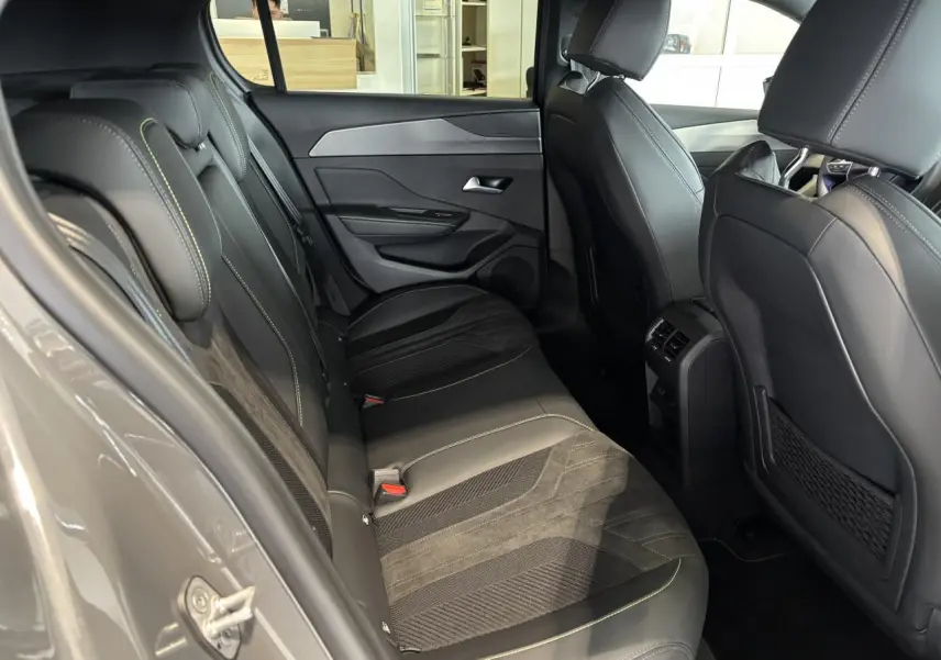 Vue intérieure côté gauche montrant la banquette arrière en Alcantara noir avec surpiqûres vert Adamite du Peugeot 308 gris selenium.