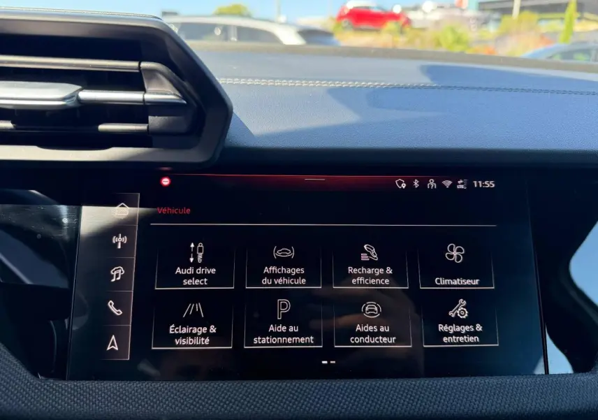 Vue intérieure du tableau de bord de l'Audi A3 Sportback 2025 avec écran multifonction affichant les réglages du véhicule.