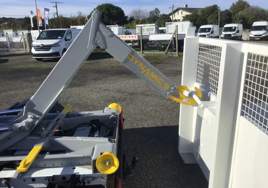 Gros plan sur le bras polybenne gris et jaune du Ford Transit Chassis Cabine blanc, vue arrière droite.
