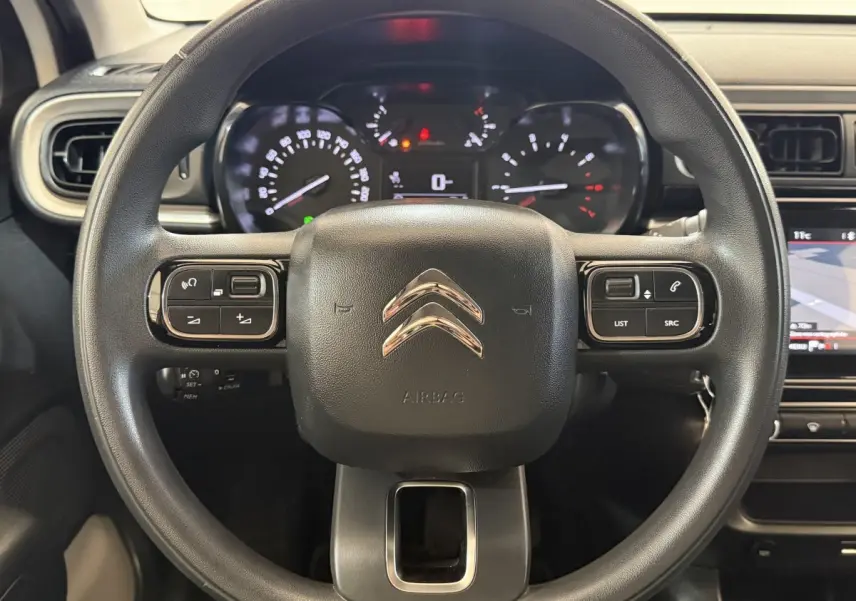 Vue rapprochée du volant multifonctions noir de la Citroën C3 2021 avec tableau de bord et écran tactile visibles.