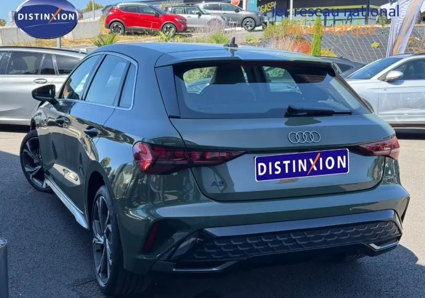 Audi A3 Sportback 40 TFSI e vert District métallisé vue 3/4 arrière avec jantes alu et feux LED distinctifs.