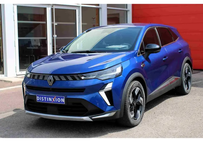 Renault Symbioz bleu 3/4 avant droit, calandre noire avec logo central et jantes alliage 19 pouces design moderne.