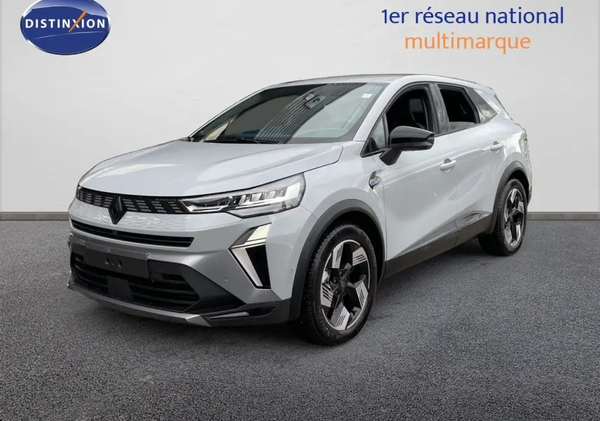 Renault Symbioz gris Rafale métal en 3/4 avant droit, SUV hybride avec détails noirs et jantes stylisées.