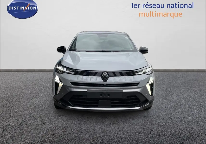 Renault Symbioz gris Rafale métal, vue de face, mettant en valeur ses phares LED et sa calandre moderne.