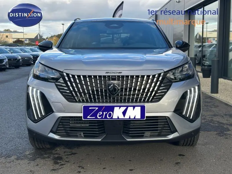 Vue frontale d'un Peugeot 2008 gris avec calandre verticale et feux LED en griffes distinctifs.