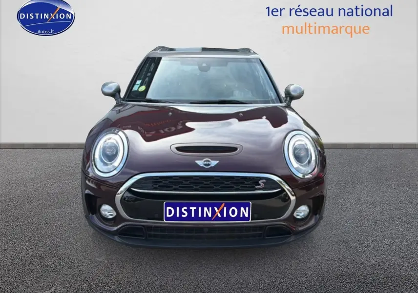 Vue frontale d'une MINI Clubman Cooper SD bordeaux avec calandre chromée et phares ronds LED.
