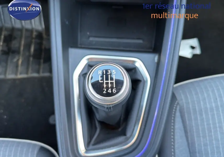 Gros plan sur le levier de vitesses manuel de la Renault Clio 2025, intérieur tissu gris avec surpiqûres visibles.