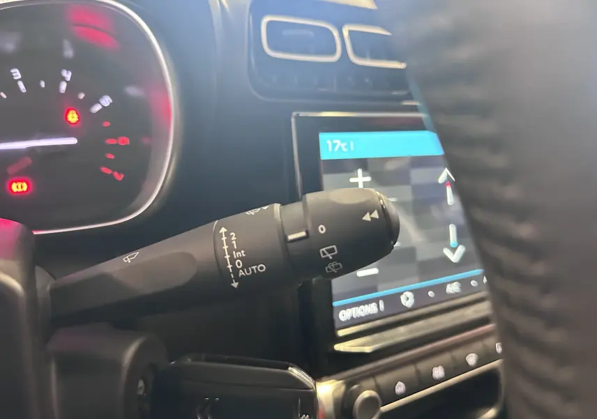 Gros plan sur la commande d’essuie-glace à gauche du volant dans l’habitacle d’une Citroën C3 Aircross 2024.