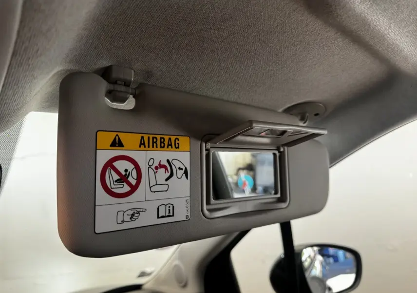 Détail du pare-soleil côté conducteur avec miroir de courtoisie ouvert dans une Citroën C3 gris foncé 2019.