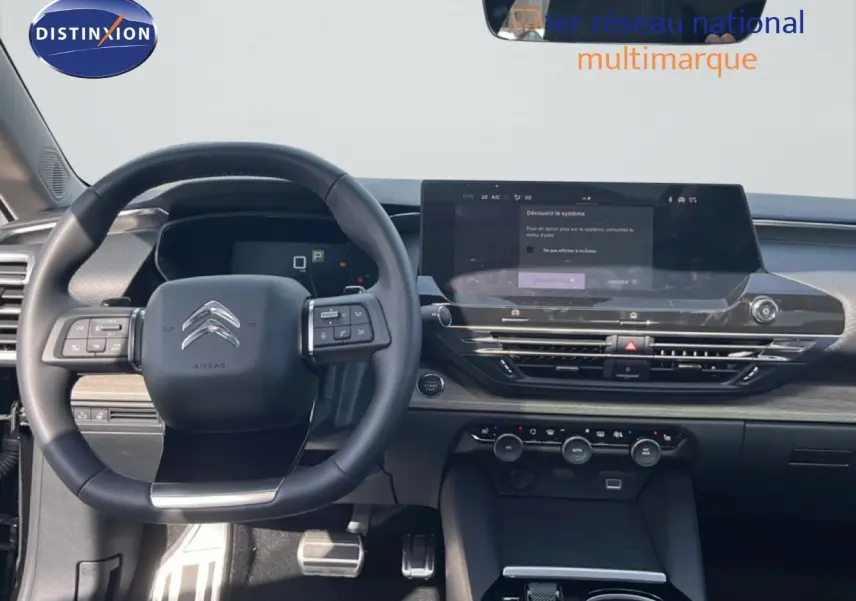 Vue intérieure du tableau de bord et volant noir de la Citroën C5 X 2023 avec écran tactile large et commandes intégrées.