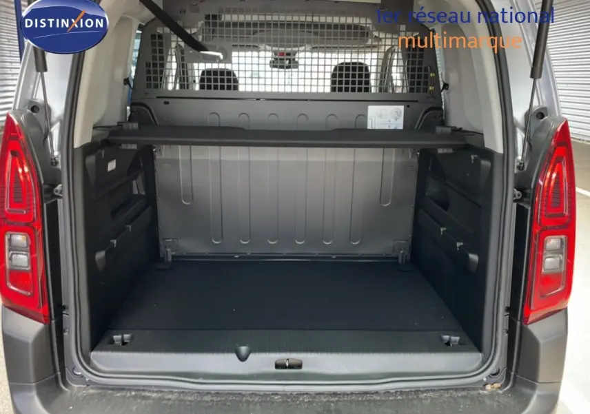 CITROEN Berlingo gris Artense métal vu de l'arrière, coffre ouvert avec séparation métallique et espace de chargement vide.