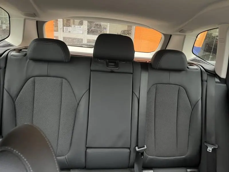 Vue intérieure arrière de la banquette en tissu anthracite du BMW X3 xDrive30e 2020 avec appuie-têtes et ceintures de sécurité.