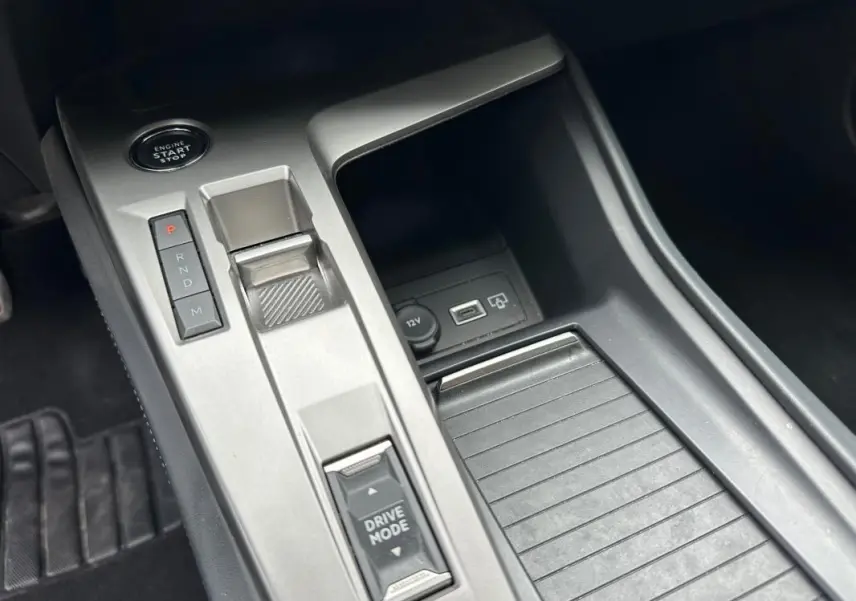 Gros plan sur la console centrale de la Peugeot 308 2023 avec bouton start/stop et commandes de boîte manuelle.