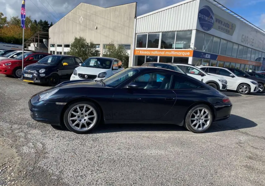 Profil côté gauche d'une Porsche 911 Targa 996 gris foncé avec jantes Sport Design 18 pouces, stationnée en extérieur.