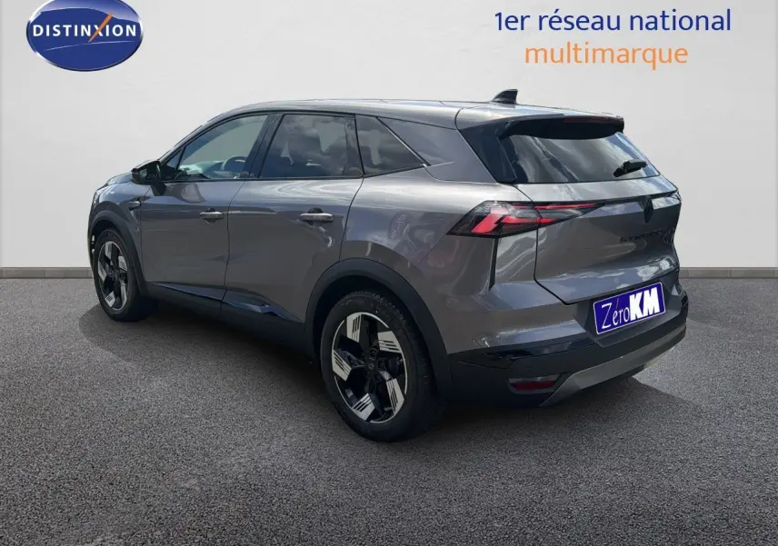 Renault Symbioz gris cassiopée métal vu en 3/4 arrière droit, avec jantes bicolores et feux arrière LED distinctifs.