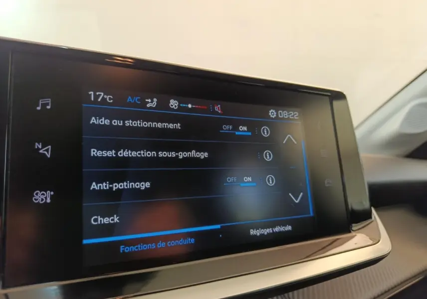 Écran tactile central affichant les réglages d’aide à la conduite dans une Peugeot 208 blanche, vue intérieure.