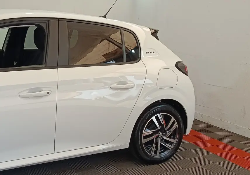 Vue latérale droite d'une Peugeot 208 PureTech 75 S&S Style blanche avec jantes alliage et badge Style arrière.