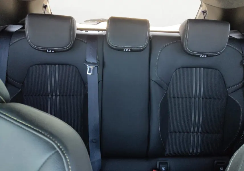 Vue intérieure sur la banquette arrière noire avec appuie-têtes et ceinture centrale de la Renault Clio V E-Tech hybride 2023.