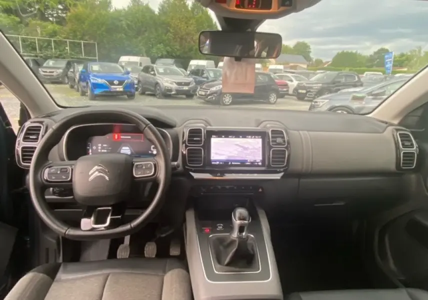 Vue intérieure du poste de conduite du Citroën C5 Aircross 2021 avec volant multifonction et écran tactile central.