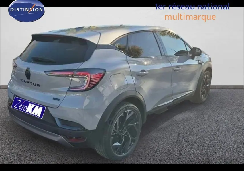 Renault Captur E-Tech hybride gris Rafale, vue 3/4 arrière droit avec toit gris et jantes noires.