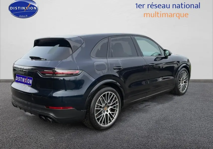 Vue 3/4 arrière droite d'un Porsche Cayenne bleu foncé avec jantes alliage et feux arrière LED.