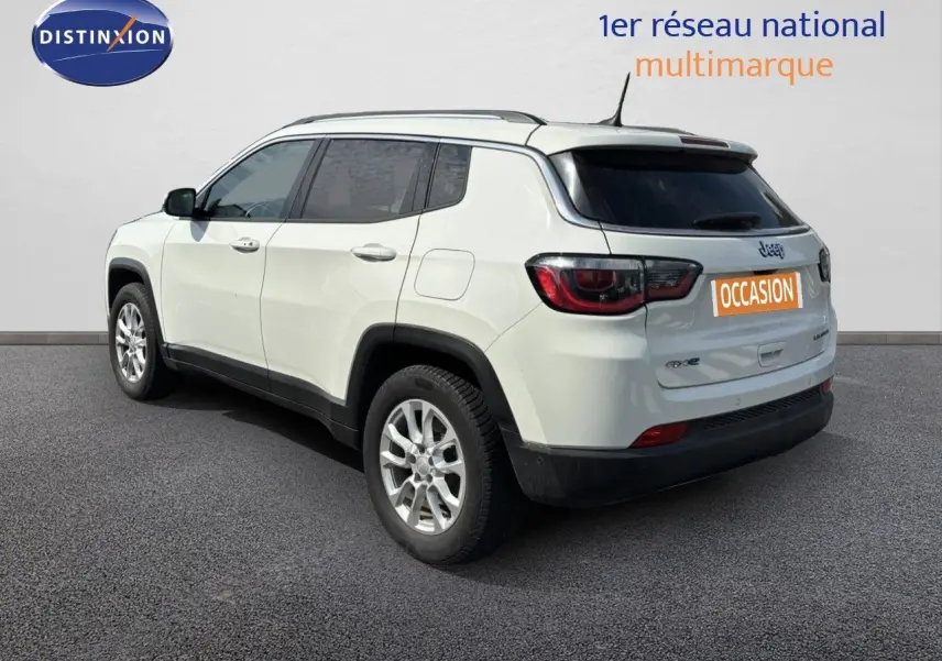 Jeep Compass blanc vue 3/4 arrière droit, SUV hybride rechargeable avec jantes alliage et vitres teintées.