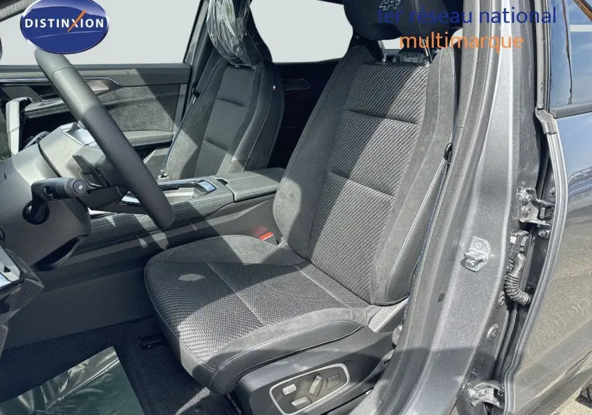 Vue intérieure côté conducteur du Renault Austral gris schiste avec sièges en tissu et cuir noir, volant multifonction et détails modernes.