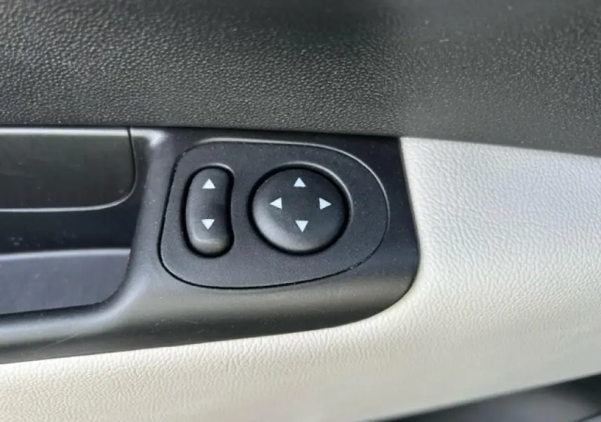 Boutons de réglage des rétroviseurs électriques sur la portière côté gauche d'une Fiat 500C gris et rouge.
