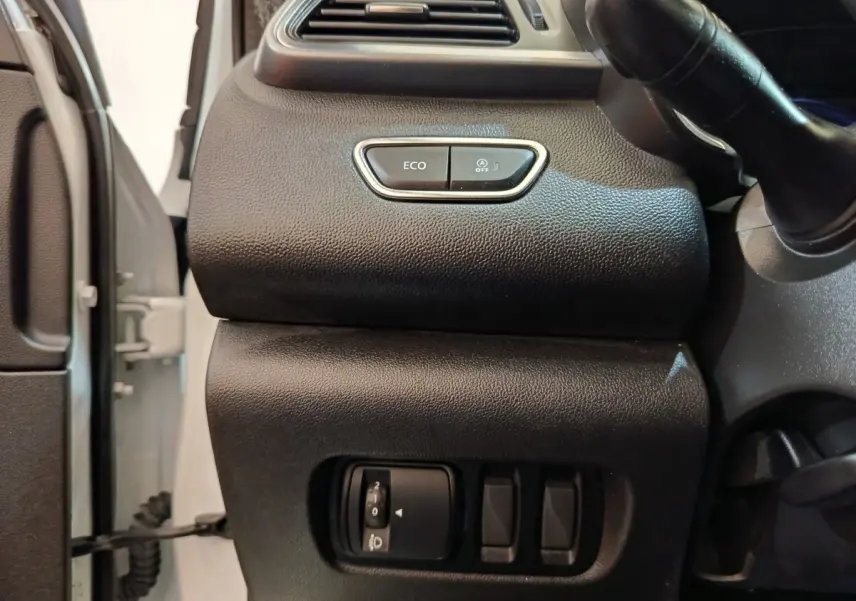 Vue intérieure côté gauche du tableau de bord noir du Renault Kadjar blanc, avec boutons Eco et réglage phares.