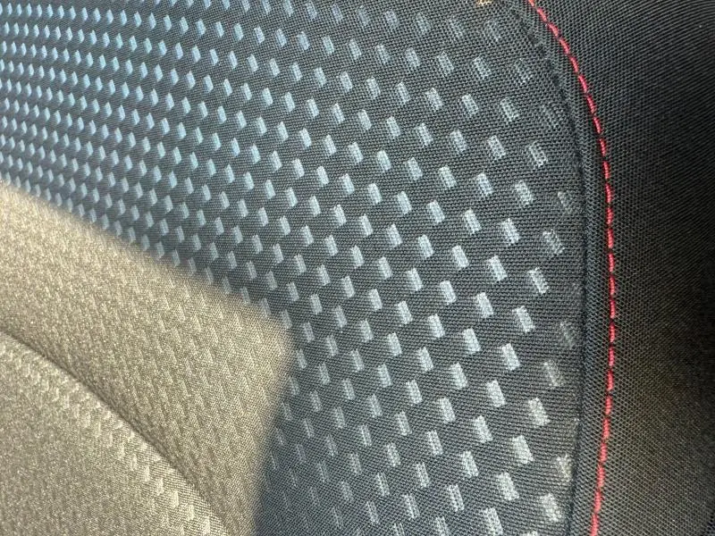 Gros plan sur le tissu noir Foundry/Eton du siège avant sport avec surpiqûres rouges du Ford Kuga 2.0 EcoBlue 2024.