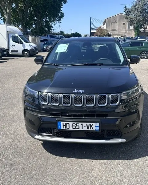 Vue avant d'un Jeep Compass noir 2025 avec calandre distinctive et plaques d'immatriculation françaises visibles.