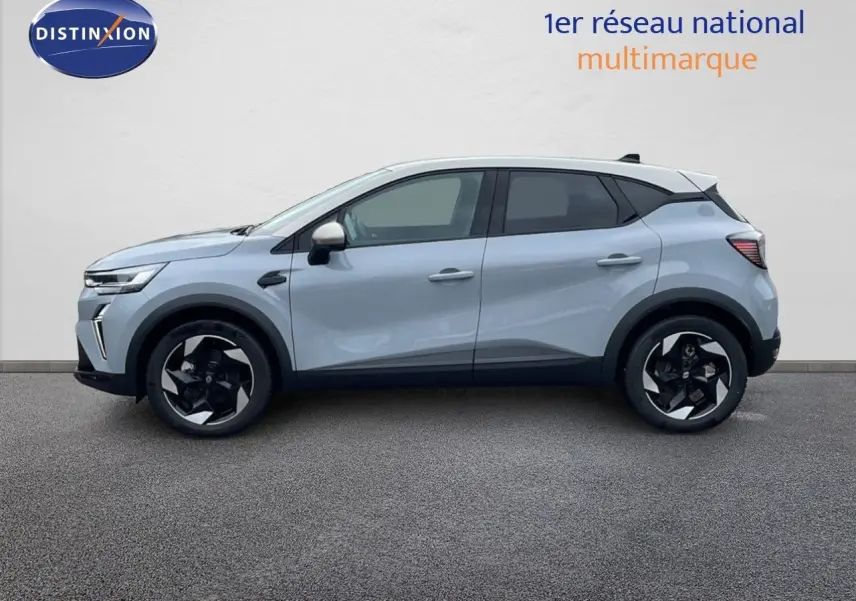 Vue latérale droite du Renault Captur 2025 gris rafale métal avec toit beige et jantes noires distinctives.