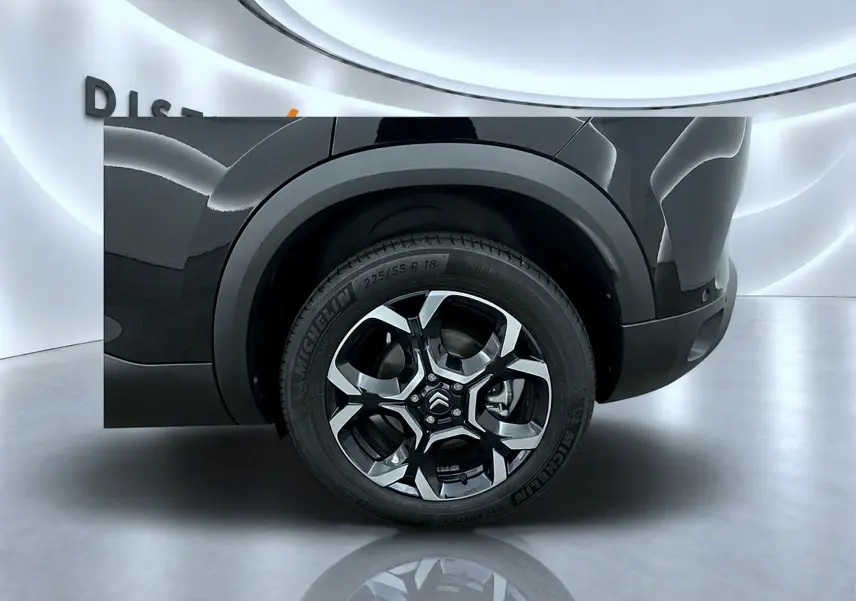 Gros plan sur la roue arrière droite d’un Citroën C5 Aircross noir avec jante alu bicolore et pneu Michelin.