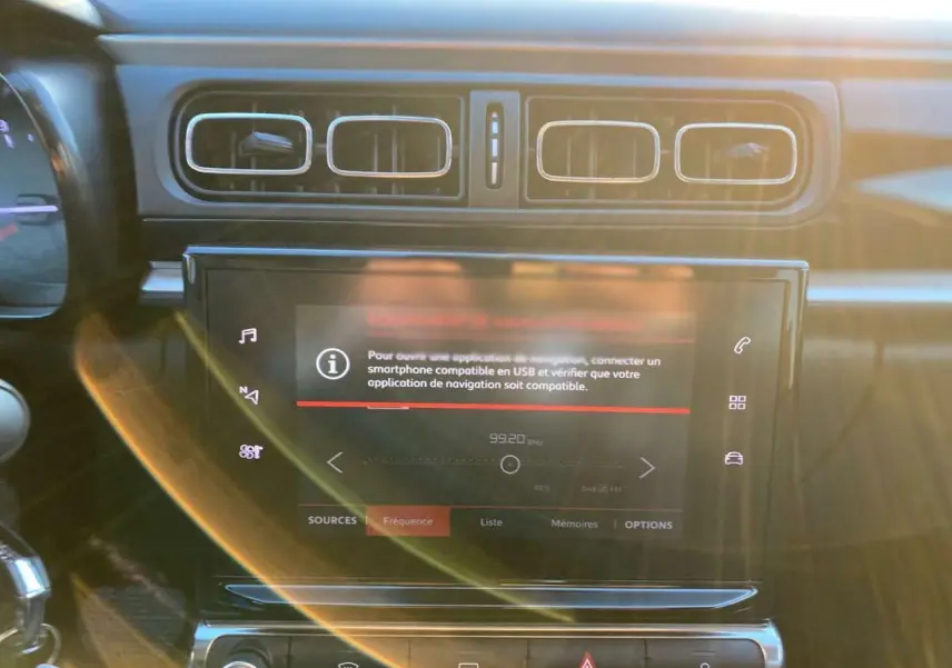 Écran tactile central avec commandes multimédia et aérateurs rectangulaires dans l'habitacle d'une Citroën C3 Shine 2023.